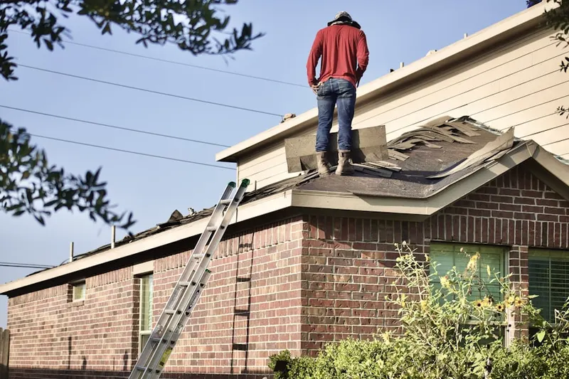 Professional roofer working on a residential roof in North of Montana